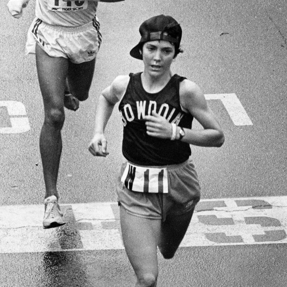 iconic picture in the Boston Marathon with a runner finish the race An iconic picture in the Boston Marathon about a girl finish the race