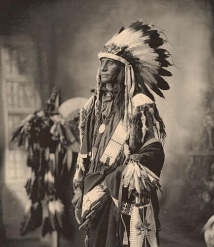 Black and White picture of a Native American man with unique fashion style
