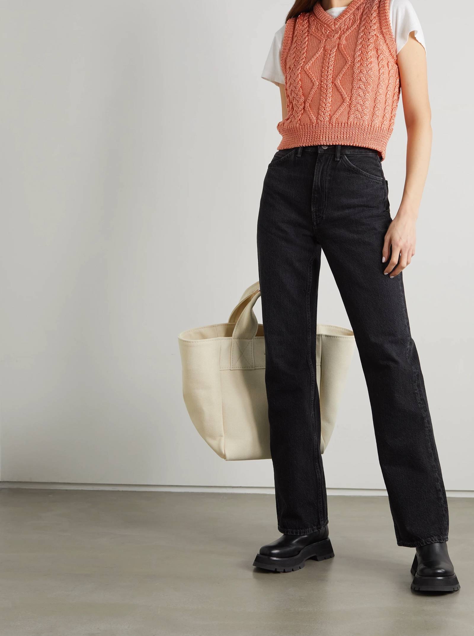 the combination of a sweater vest with jeans is perfect for an outdoor day