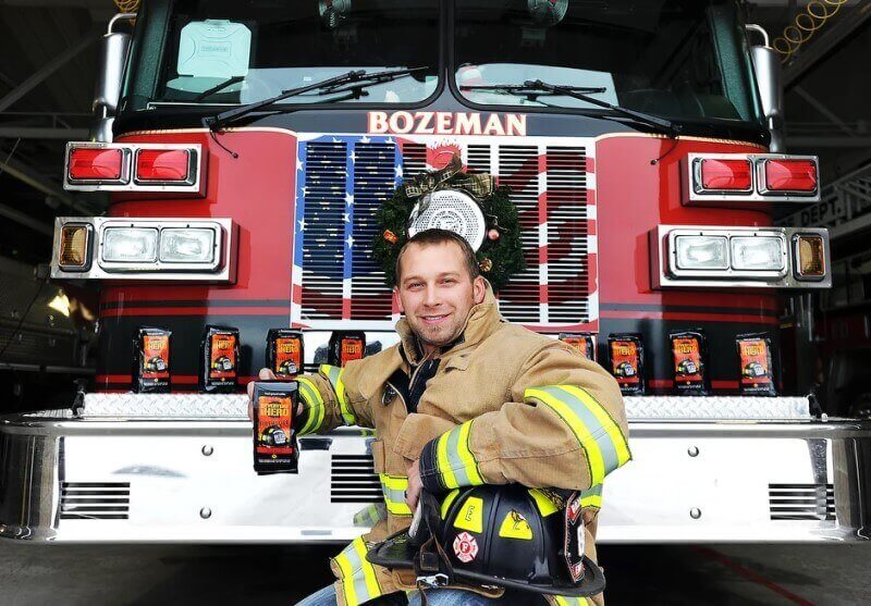 firefighter with cups near the firetruck